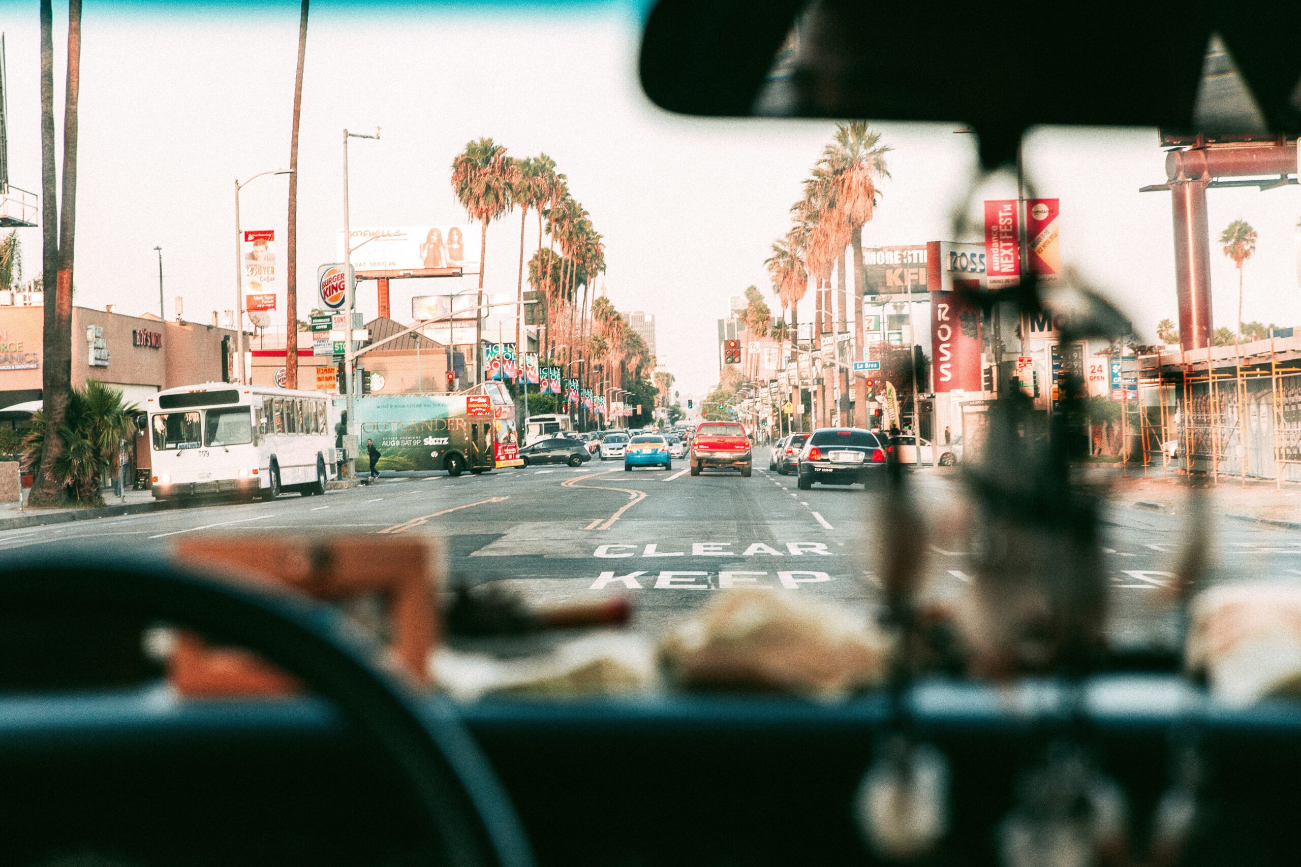 A POV of driving a car towards an intersection in a city