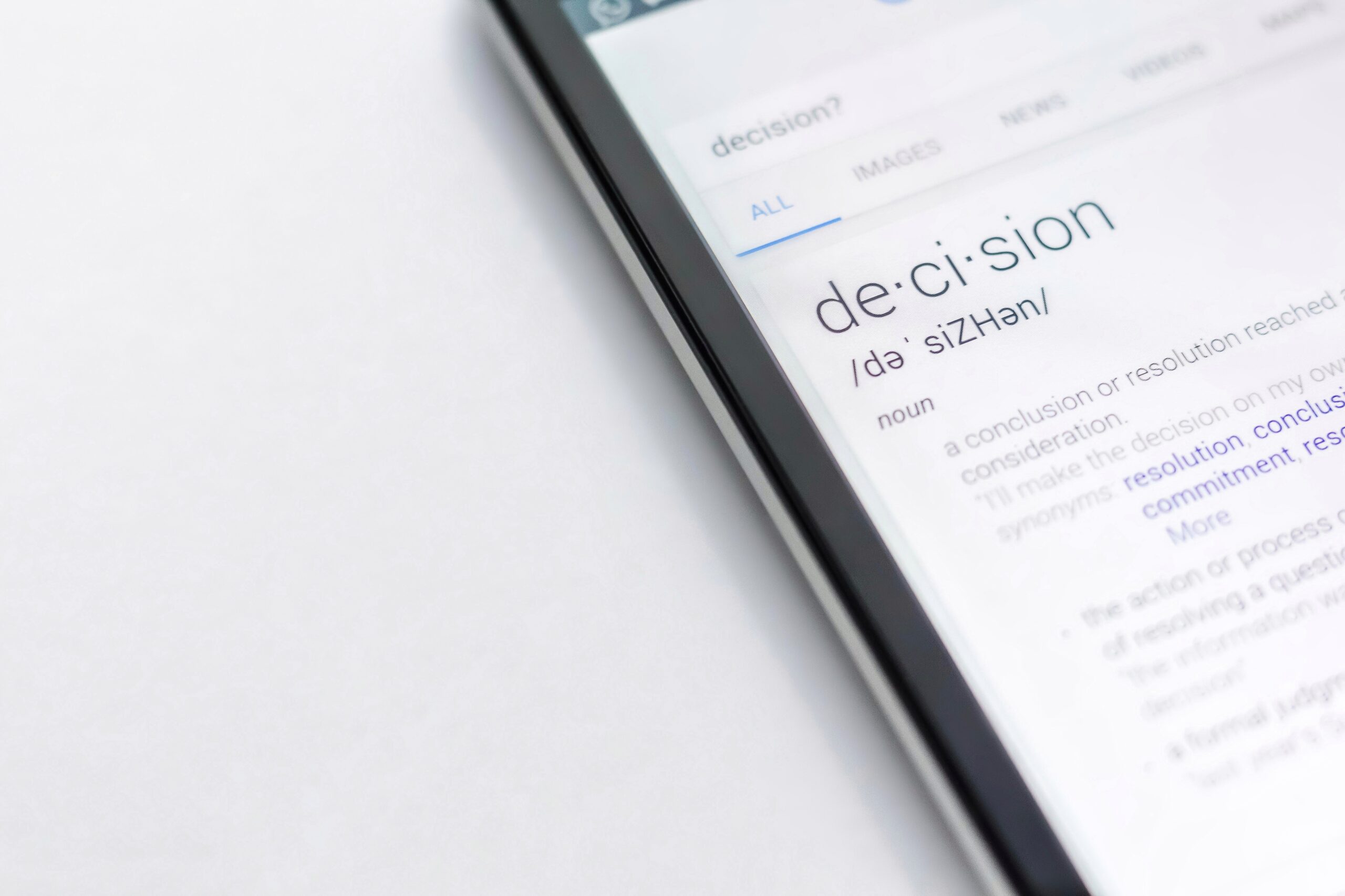 A tablet with the definition of the word "decision" on it, what words to learn