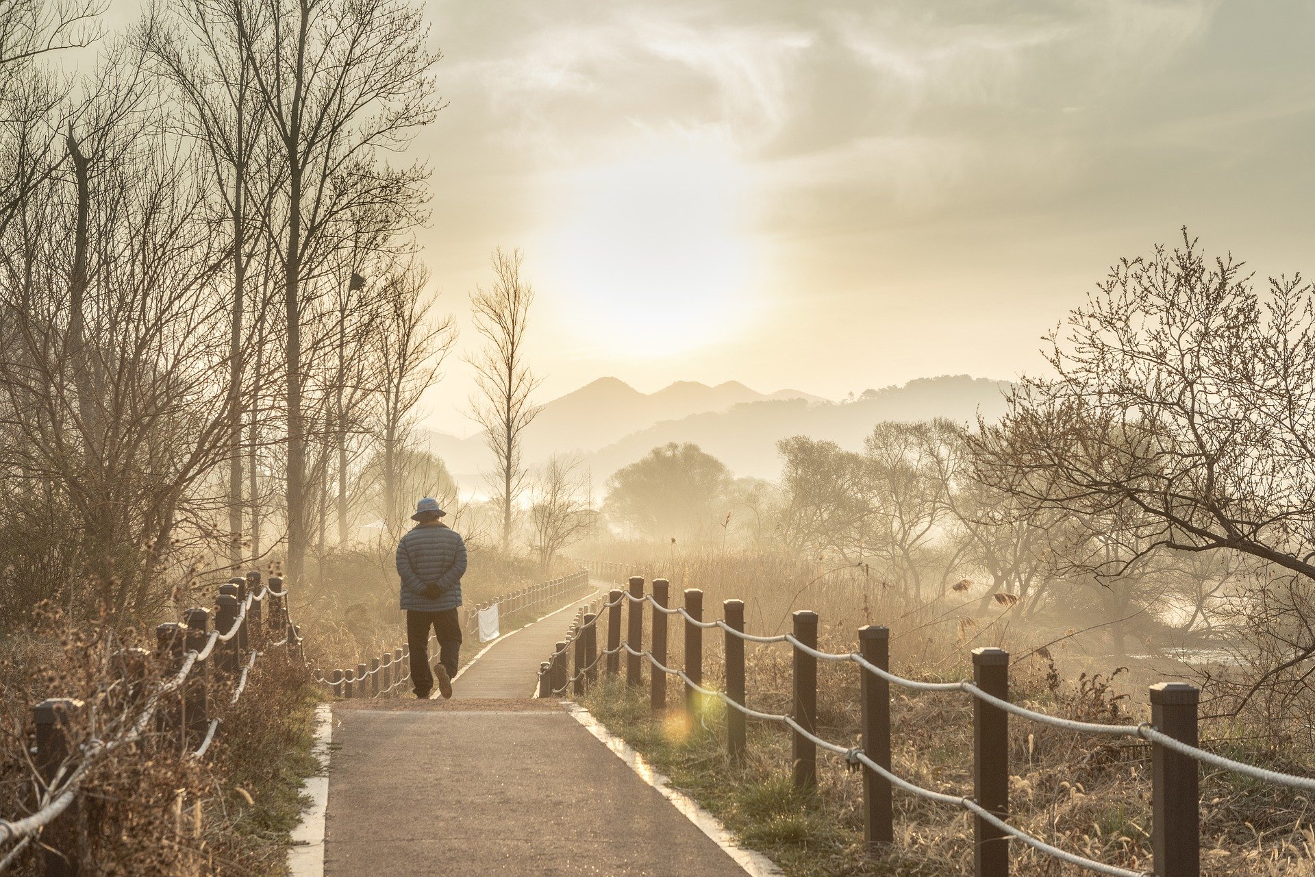 A man taking a morning walk on a paved walkway